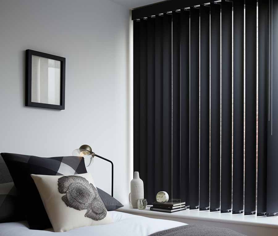 Black Vertical Blinds In A Bedroom